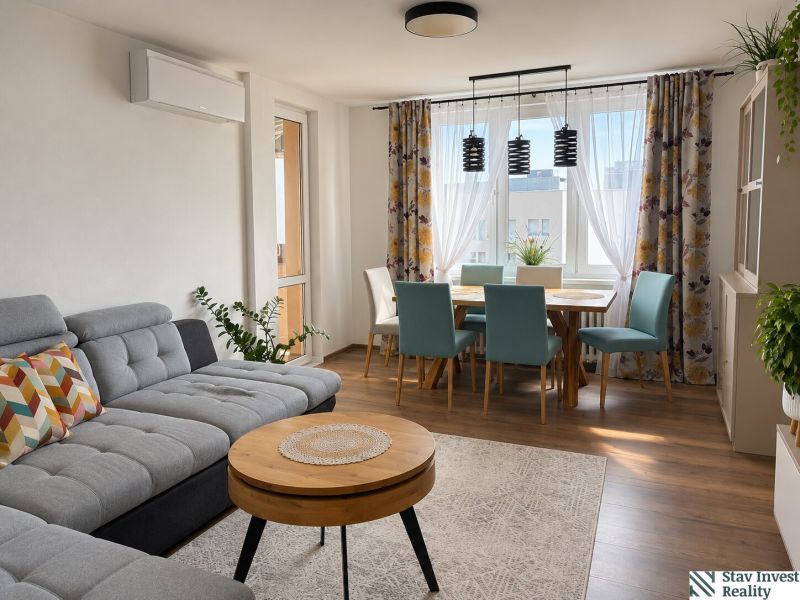 Living room in a 3-room apartment with a sofa, dining table, and wooden decor flooring.