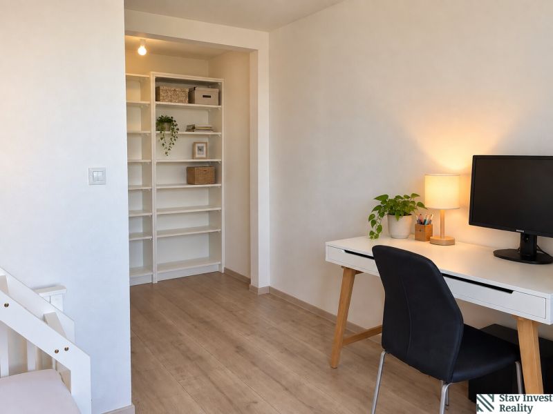 A workspace with a computer and shelves in a 3-room apartment, flooring with a wooden decor.
