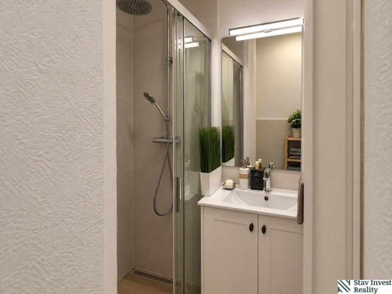 A bathroom with a shower and a sink in a 3-room apartment.