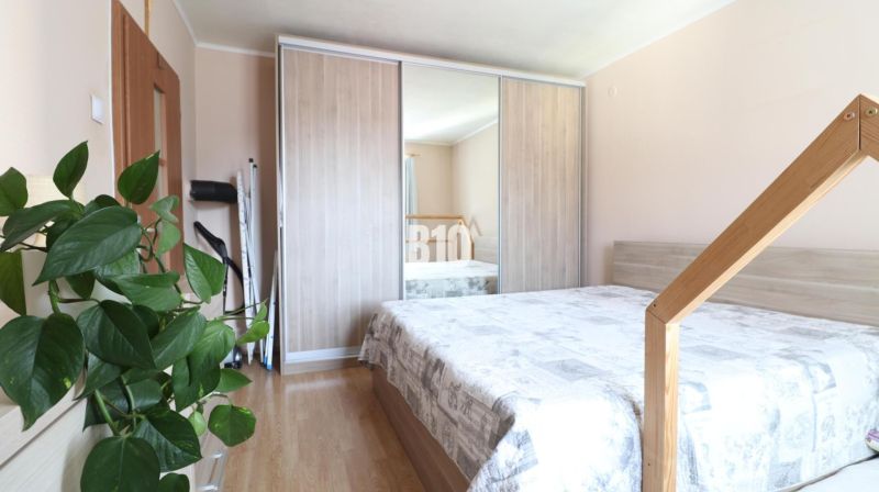 A bedroom with a double bed and a built-in wardrobe in a 3-room apartment.