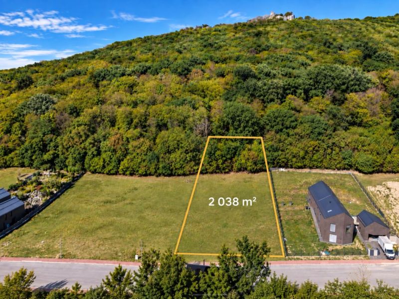 Development land in Borinka with an area of 2038 m², surrounded by greenery and hills.