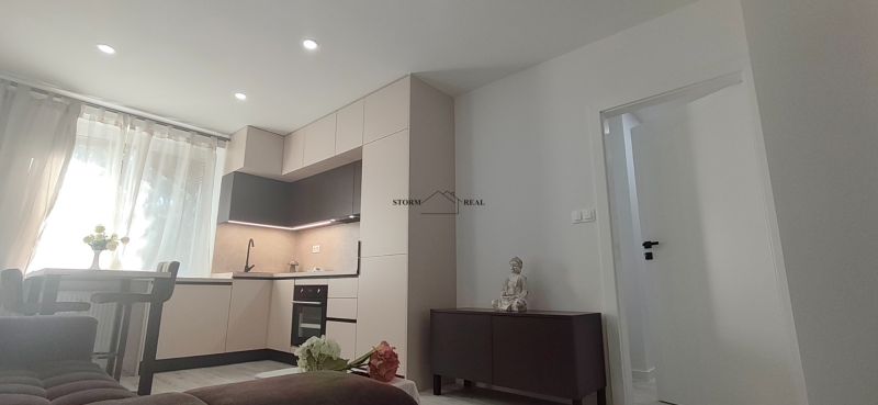 Kitchen with a kitchen unit, table, and decorative elements in a 3-room apartment.