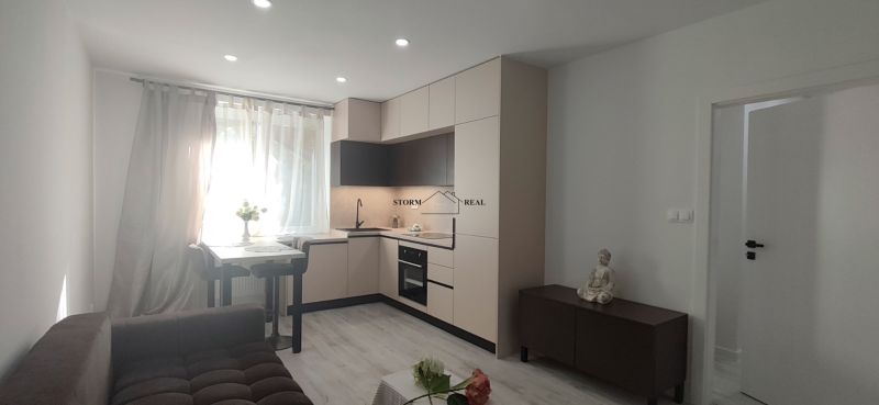 A kitchen with a corner kitchen unit in a 3-room apartment, floor with a wooden decor.