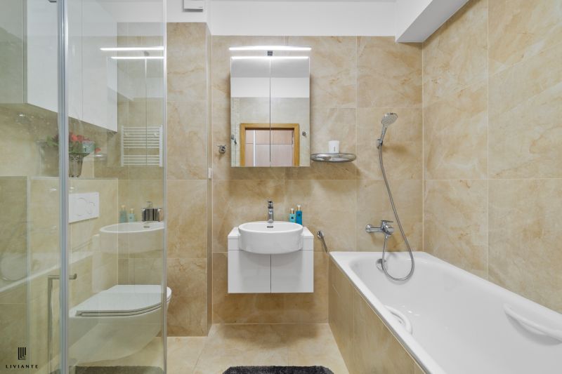 Elegant bathroom in a 3-room apartment with a bathtub and a shower.