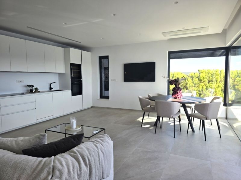 A spacious living room with a light interior and a dining area in a 4-room apartment.