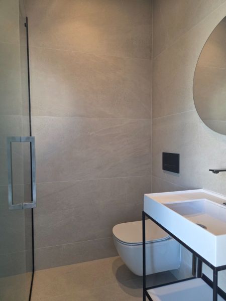 A bathroom with a shower and a sink in a 4-room apartment.