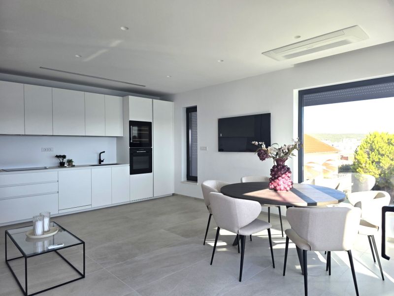 A bright kitchen in a 4-room apartment with dining and panoramic views.