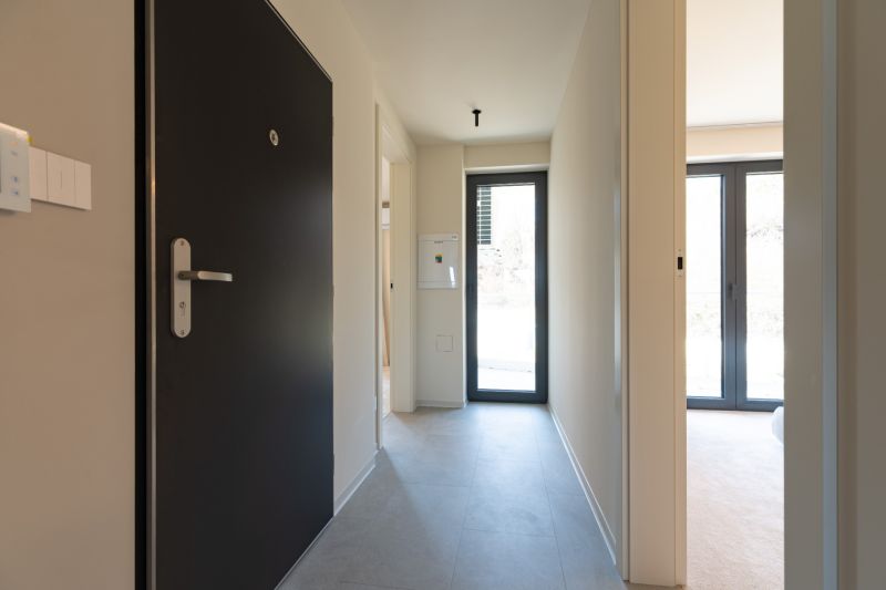 Hallway with entrance door and light in a 4-room apartment.
