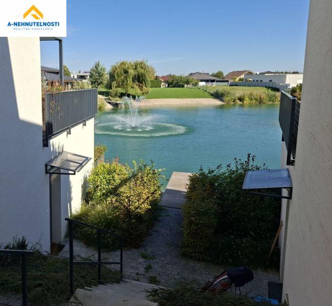 View of the lake with a fountain from the adjacent houses on Golf Street, Hrubá Borša.