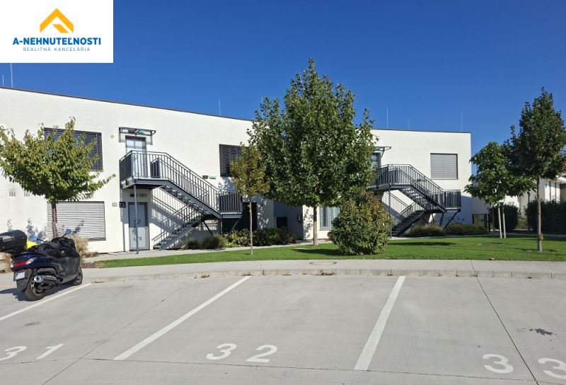 Parking lot and a modern building with an outdoor staircase on Golfová Street in Hrubá Borša.