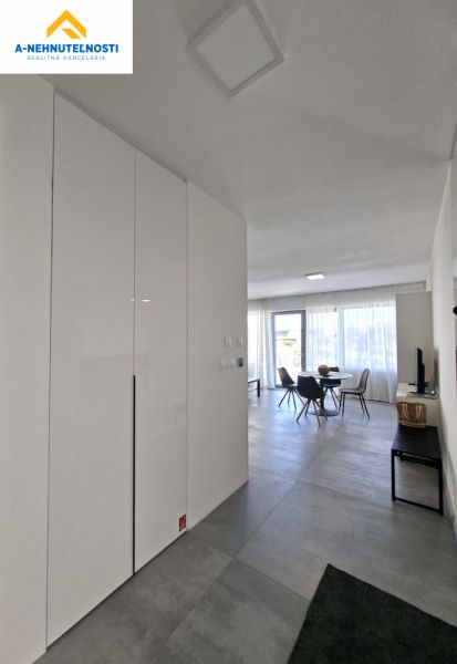 A hallway with tiles and a built-in wardrobe in a 2-room apartment.