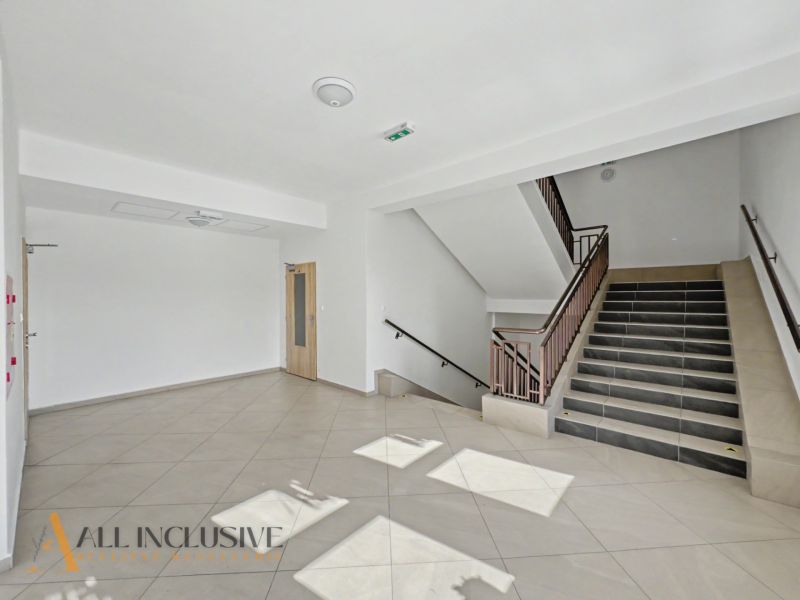 Staircase and entrance hall with tiles in a 2-room apartment.