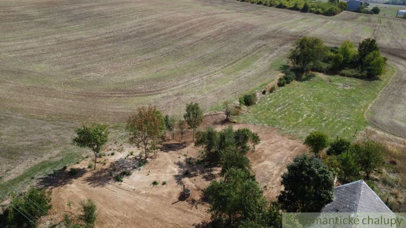 Spacious flat plots for housing in Dedinka, surrounded by trees and fields.