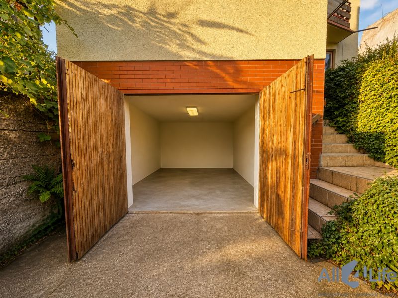 Open garage at the Cottage on Rekreačná Street in Vrbové, next to the staircase with plants.