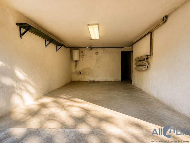 Garage in the Cottage on Rekreačná Street in Vrbové with a concrete floor and lighting.