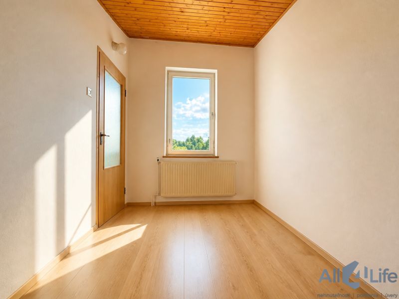 The interior of a cabin with a wooden decor floor and a view from the window.