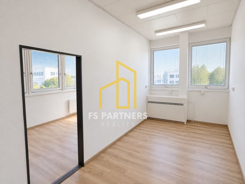 Offices with large windows and wooden decor flooring.
