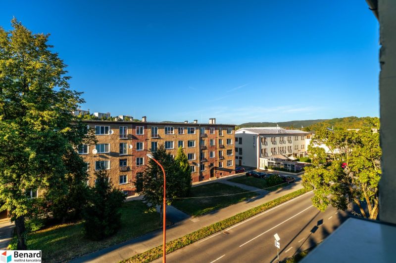 A view of residential buildings on Fučíkova Street in Bardejov on a sunny day.