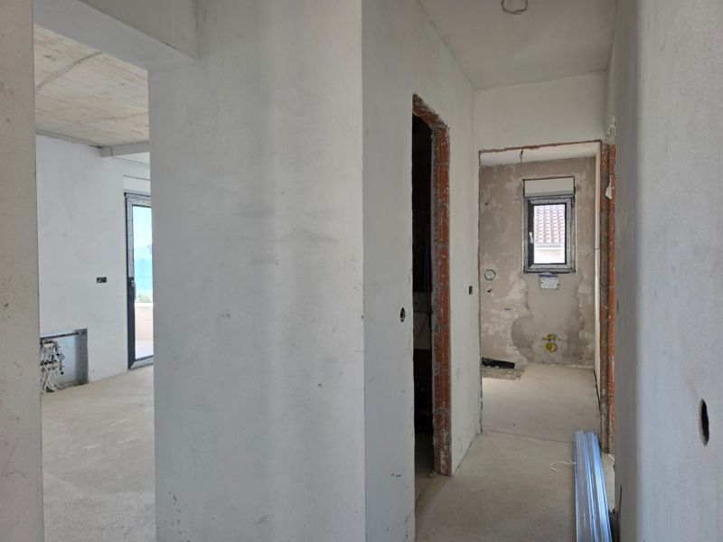 Interior of a 3-room apartment with unfinished walls and floor, ready for completion.