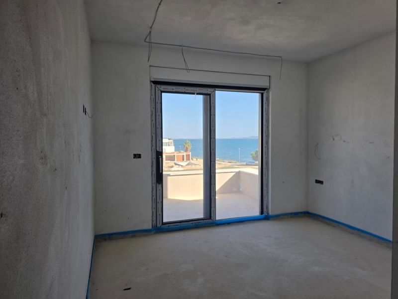 A room in a 3-room apartment with a sea view, without flooring.