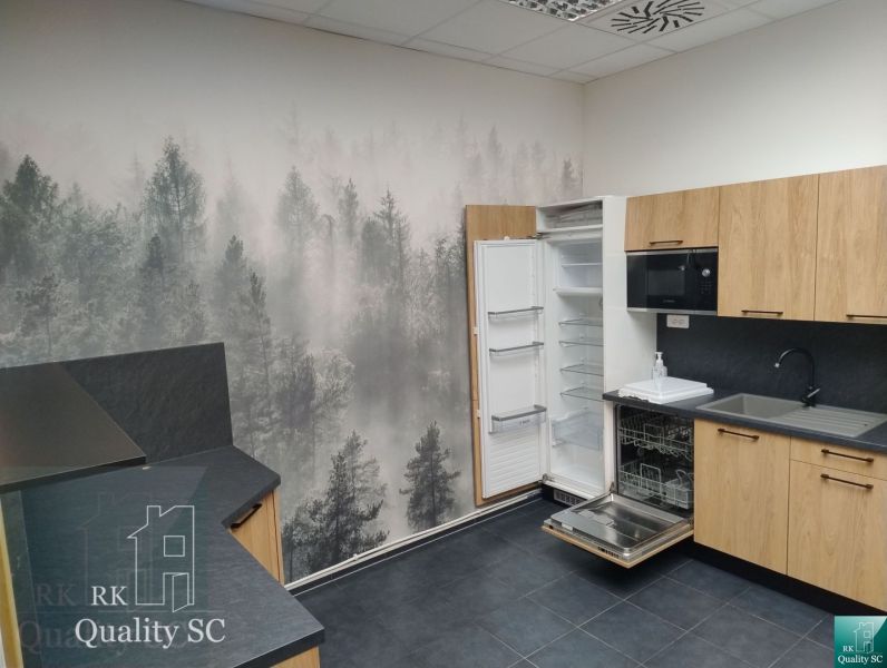 Office interior with a forest motif on the wall, floor with wooden decor.