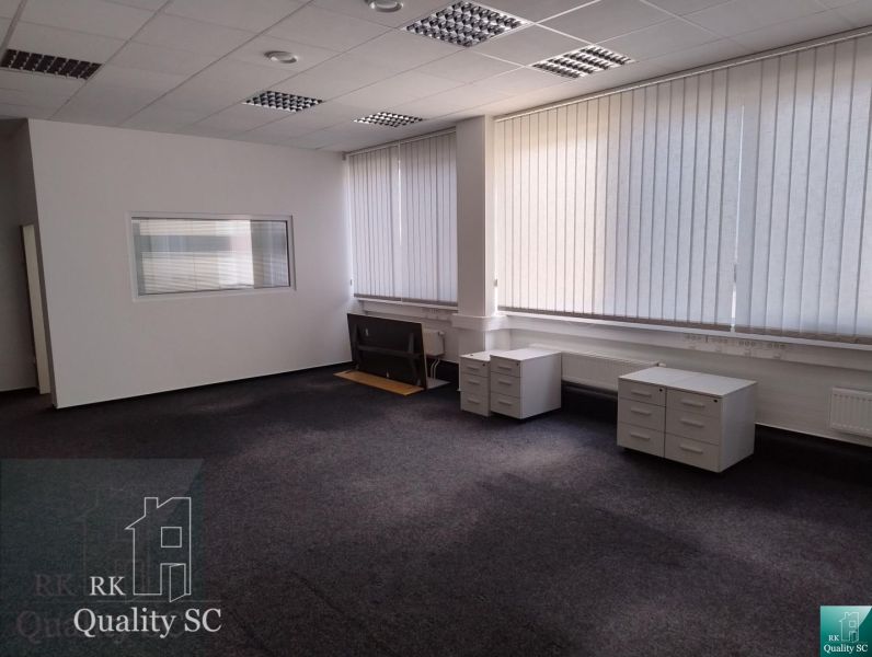 Offices with carpeted floors, white walls, and blinds on the windows.