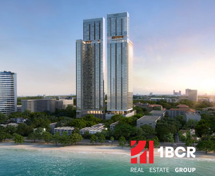 Apartment construction in Pattaya with a view of the beach and ocean.