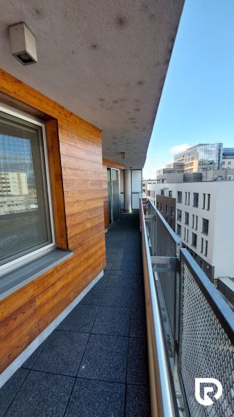 A balcony with tiles next to a facade clad in wood on Legionárska Street in Trenčín.