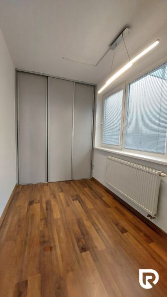 Children's room with wood-patterned flooring in a 2-room apartment.