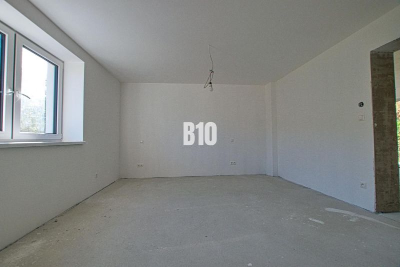 An empty room with a large window in a family house.