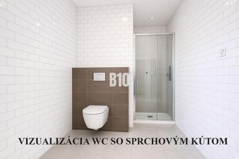 A bathroom in a family house with white tiles and a shower corner.
