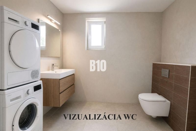Bathroom with a washing machine, dryer, wall-hung toilet, and sink in a family house.
