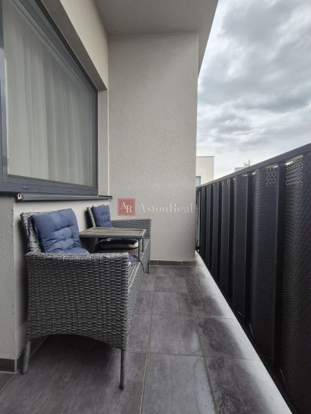 Balcony with seating and tiles, 3-room apartment, privacy for relaxation.