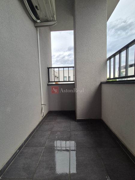 A balcony with ceramic tiles and a railing in a 3-room apartment.