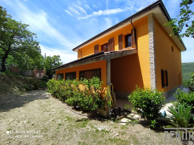 The villa on G. Puccini Street in Perugia has an orange facade and stone details.