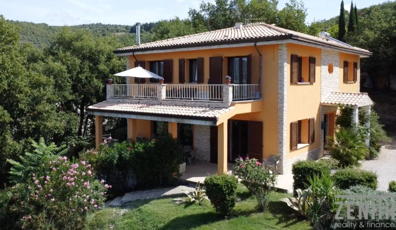 A villa on G. Puccini Street in Perugia with a terrace and green gardens.