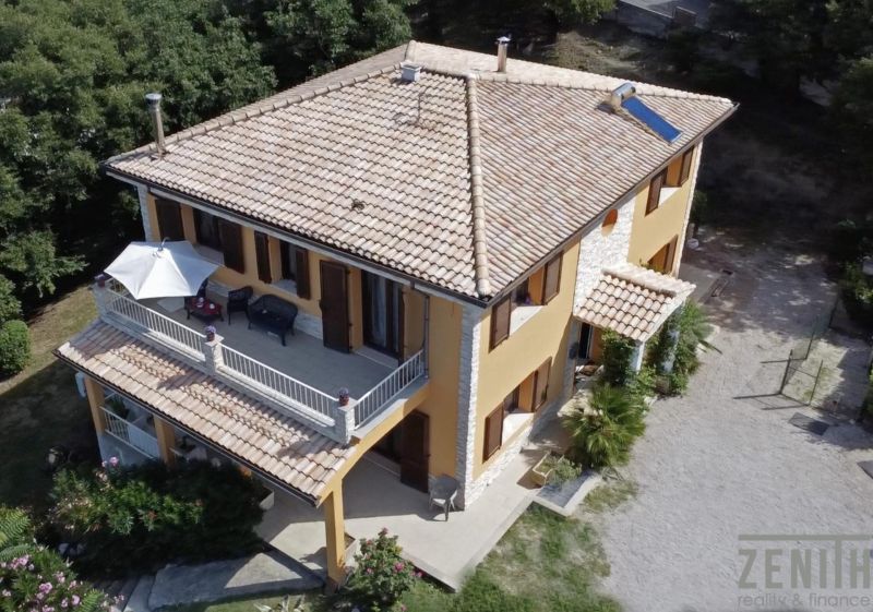 A villa on G. Puccini Street in Perugia with a terrace, surrounded by greenery and a garden.