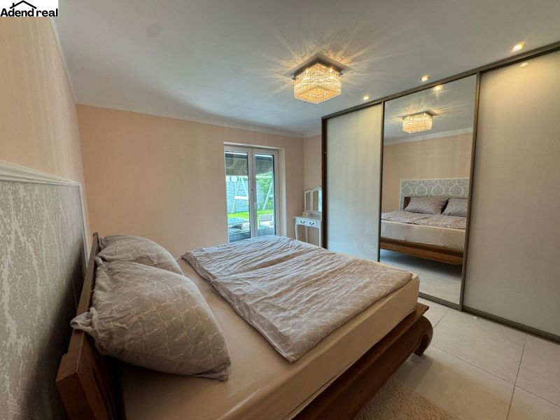 Bedroom in a family house with a large wardrobe, bed, and garden view.