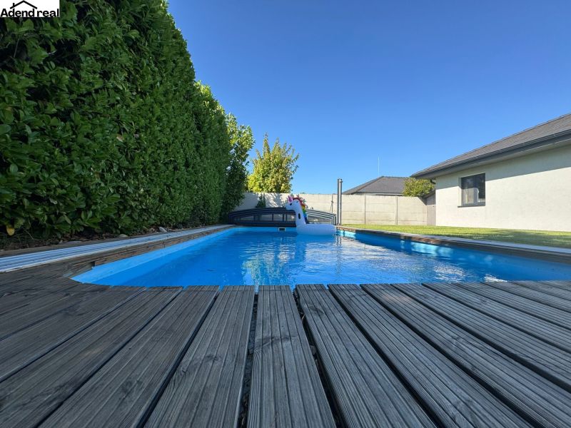 A swimming pool at a family house on Slnečnicová Street in Miloslavov, surrounded by greenery.