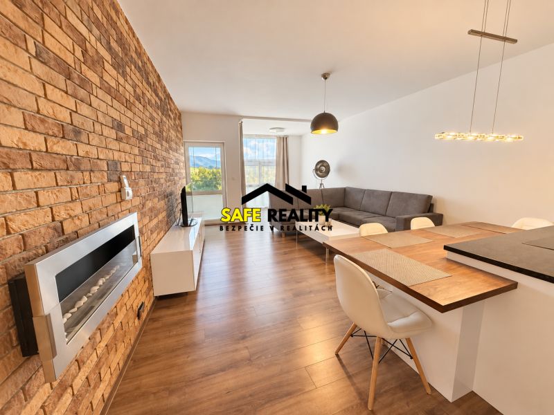 Living room with a brick wall and wood-patterned flooring in a two-room apartment.