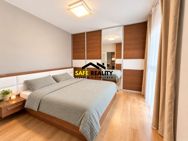 A bedroom in a 2-room apartment with a double bed and a floor with a wood decor.