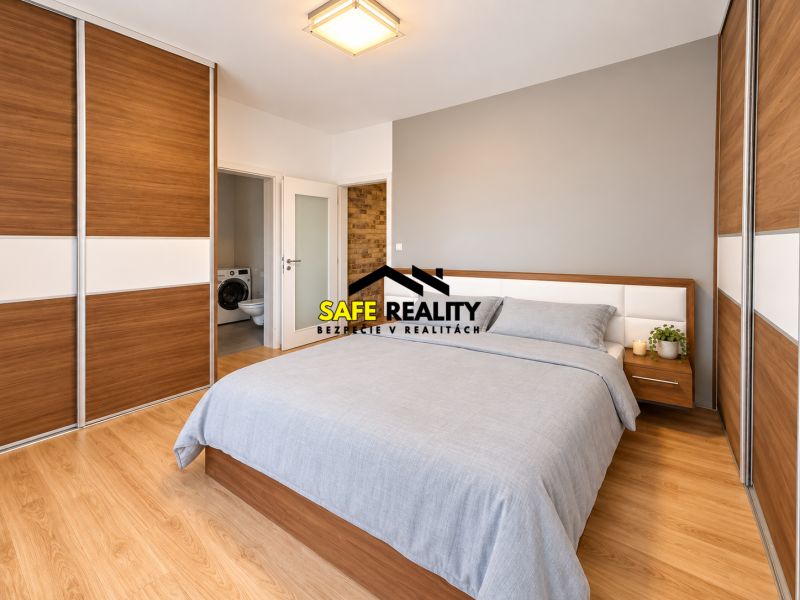 A bedroom in a 2-room apartment with a wood-patterned floor and built-in wardrobes.