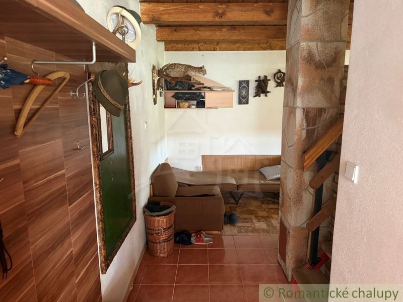 A cottage with a wooden floor decor, rustic furniture, and decorations.