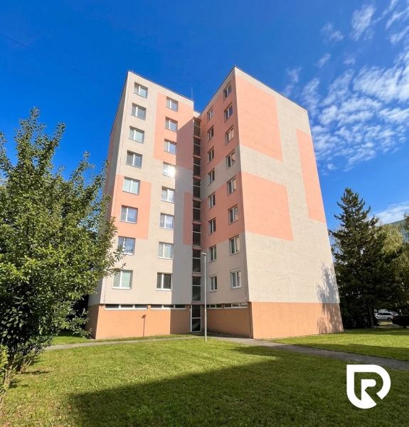 Apartment building on Žilinská in Trenčín with a diverse exterior and lawn.