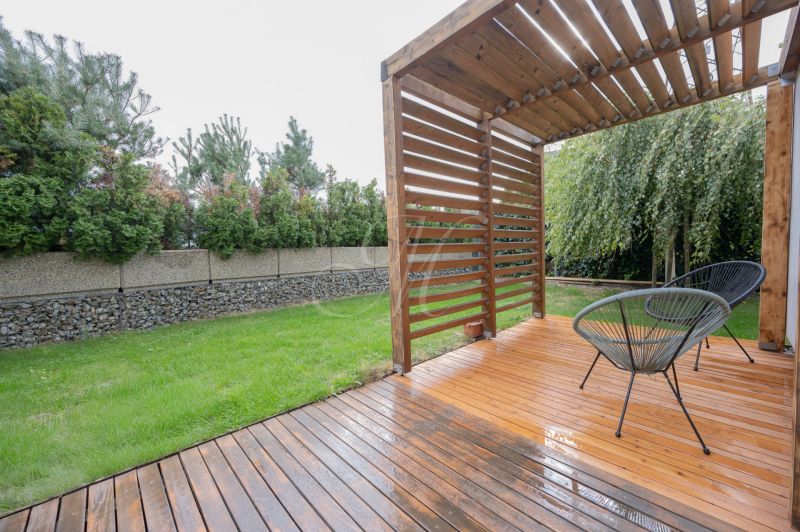 Wooden terrace with seating, lawn, hedge, 4-room apartment on Frankovská Street in Bratislava.