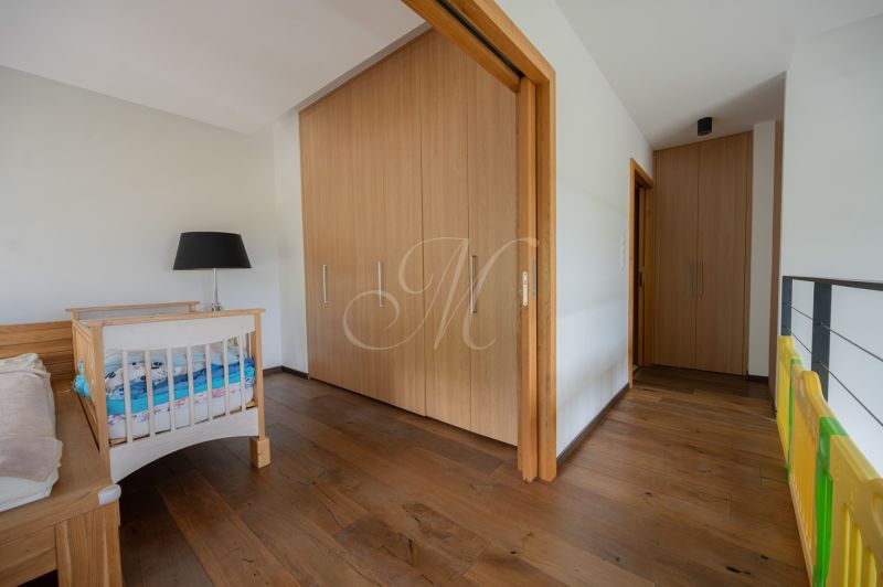 A crib, wardrobe, and floor with a wooden decor in a 4-room apartment.