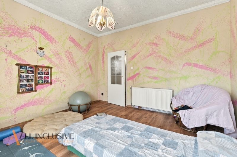 Children's room in a family house with colorful walls and a wooden decor floor.