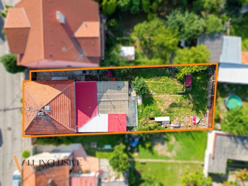 Aerial view of a family house in Komárno with a garden and terrace.