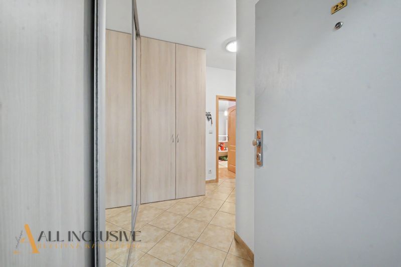 Entrance hallway in a one-bedroom apartment with tiles and a built-in wardrobe.