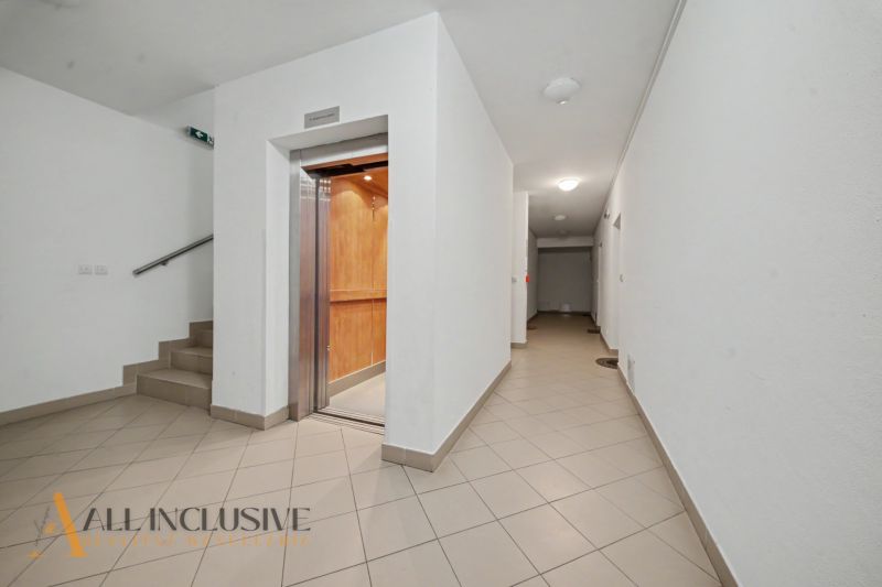 Hallway with an elevator and staircase in the building.